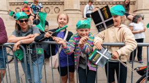 A group of people looking at the camera waving flags